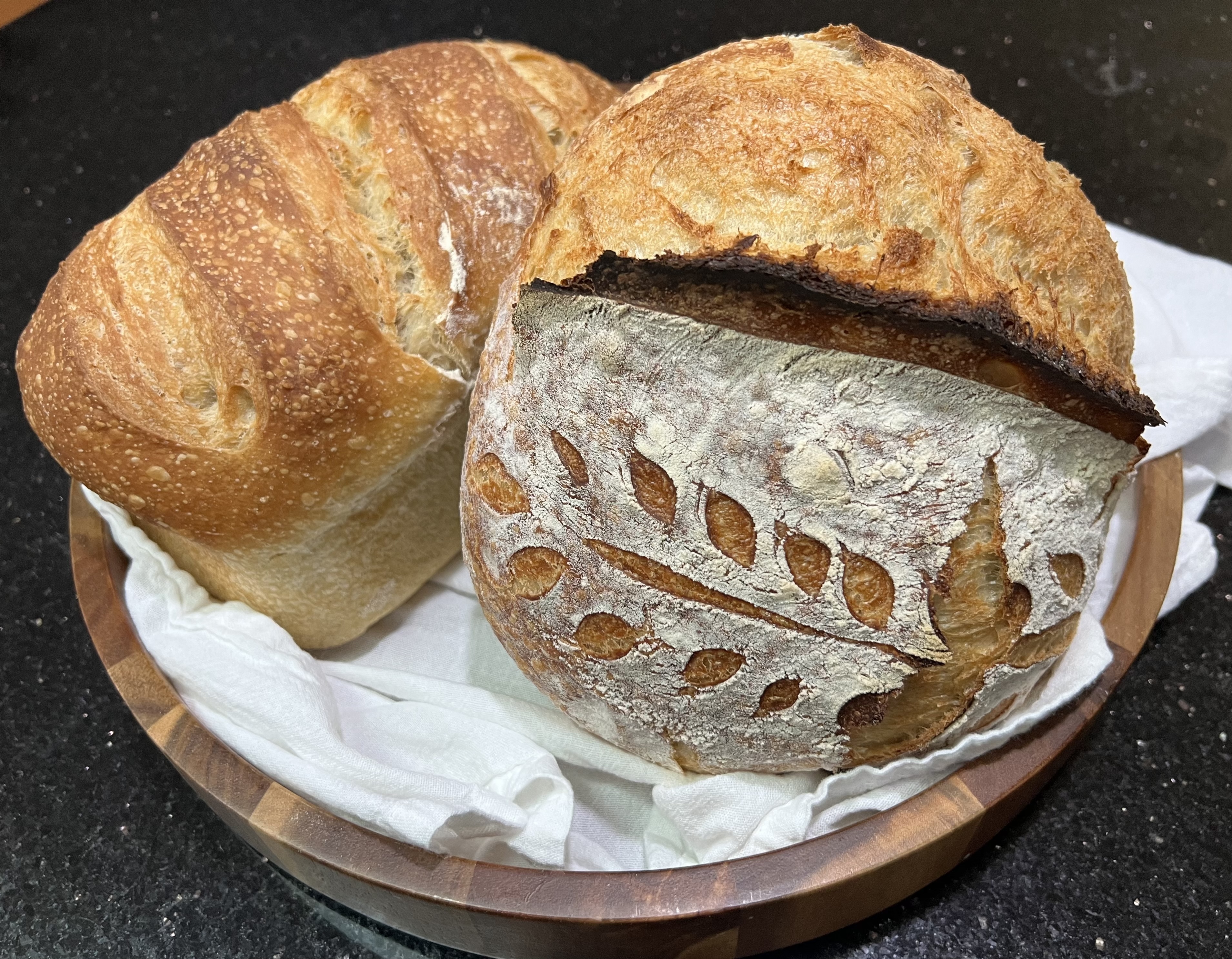 Round sourdough loaf with decorative scoring